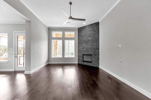 unfurnished living room featuring dark wood-type flooring, ceiling fan, ornamental molding, and a fireplace