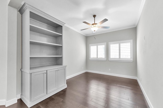 spare room featuring dark wood-type flooring, ceiling fan, and ornamental molding