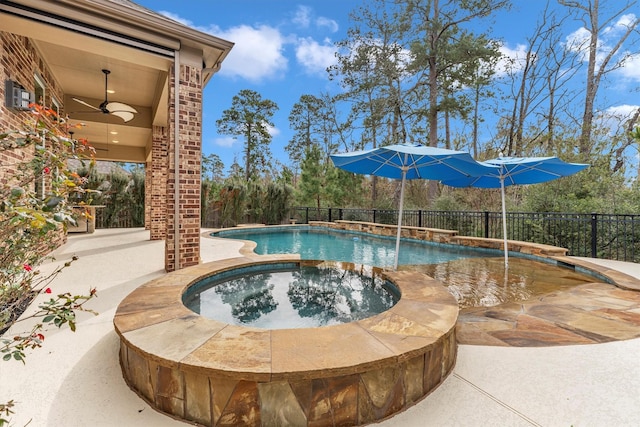 view of swimming pool with a patio area, ceiling fan, and an in ground hot tub