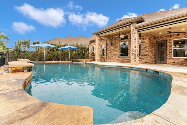 view of pool with ceiling fan and a patio