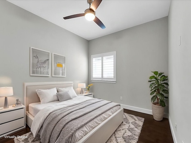 bedroom with dark hardwood / wood-style flooring and ceiling fan