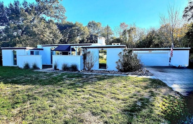 single story home with a front yard and a garage