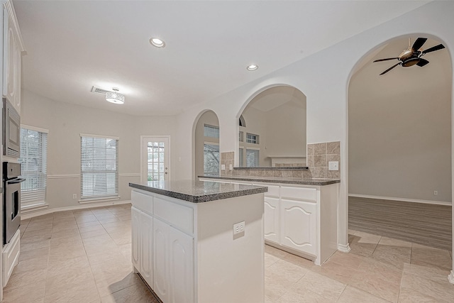 kitchen featuring appliances with stainless steel finishes, white cabinetry, and a kitchen island