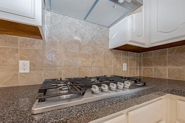 room details with backsplash, white cabinets, ventilation hood, and stainless steel gas cooktop