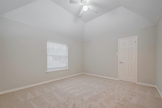 carpeted empty room with ceiling fan and lofted ceiling