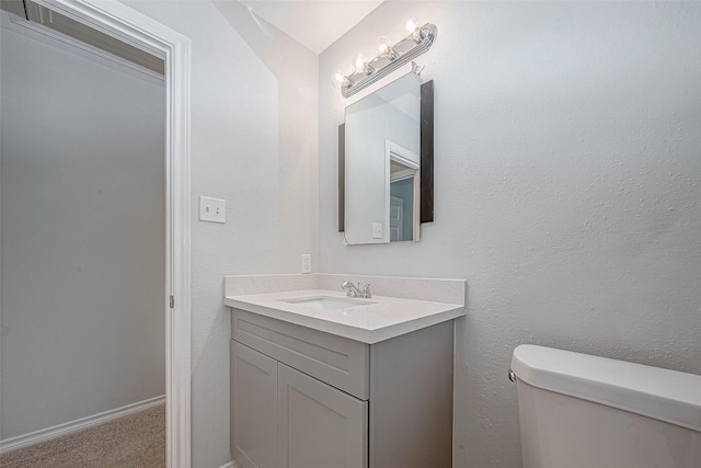 bathroom with toilet and vanity