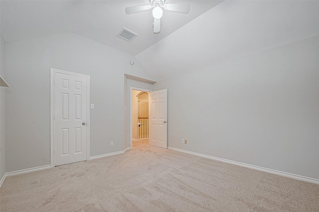 unfurnished bedroom featuring ceiling fan, lofted ceiling, and light carpet