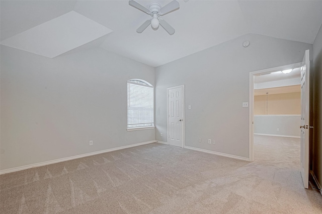 empty room with ceiling fan, light carpet, and vaulted ceiling