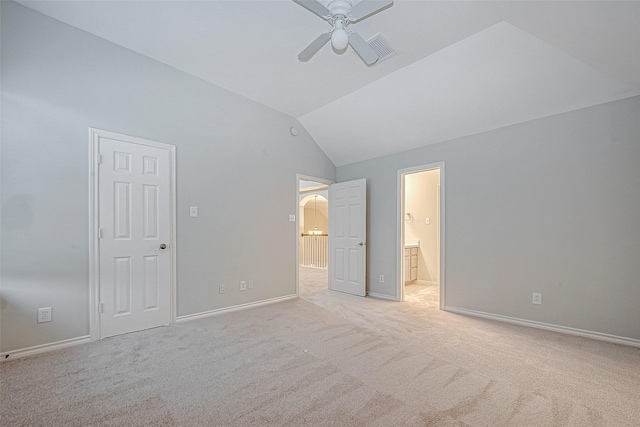 unfurnished bedroom with vaulted ceiling, ceiling fan, a closet, and light colored carpet