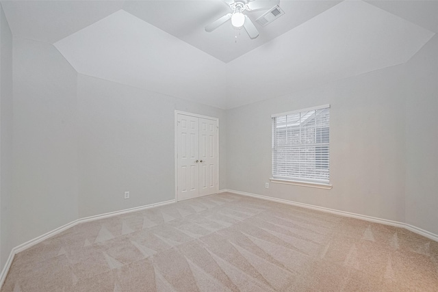 interior space with light carpet, vaulted ceiling, and ceiling fan