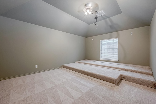 additional living space with lofted ceiling and light colored carpet