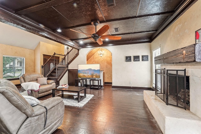 living room with coffered ceiling, dark hardwood / wood-style floors, crown molding, ceiling fan, and beamed ceiling