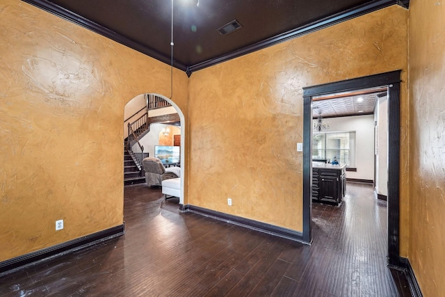 unfurnished room with crown molding and dark hardwood / wood-style flooring