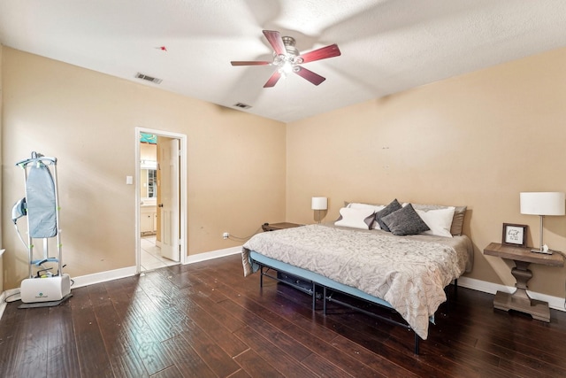 bedroom featuring ceiling fan, ensuite bath, a textured ceiling, and wood-type flooring