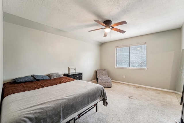 carpeted bedroom with a textured ceiling and ceiling fan