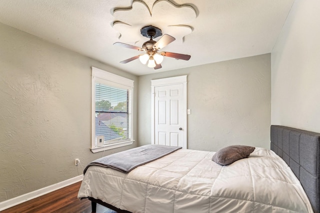 bedroom featuring ceiling fan and dark wood-type flooring