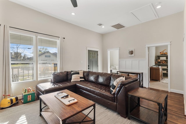 living room featuring ceiling fan, a wealth of natural light, and light hardwood / wood-style floors