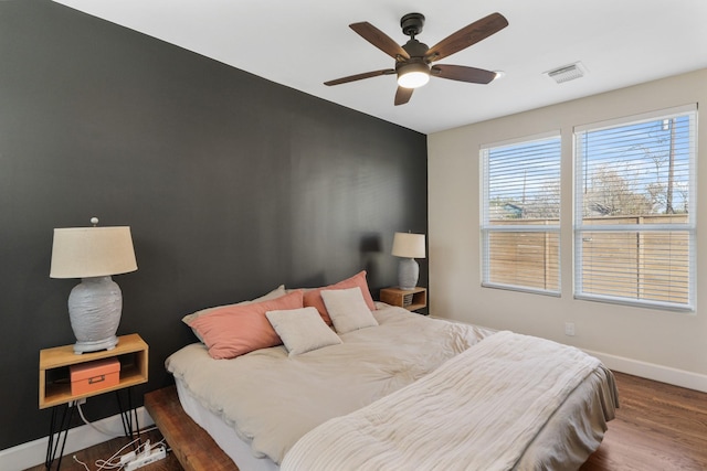 bedroom featuring ceiling fan and dark hardwood / wood-style flooring