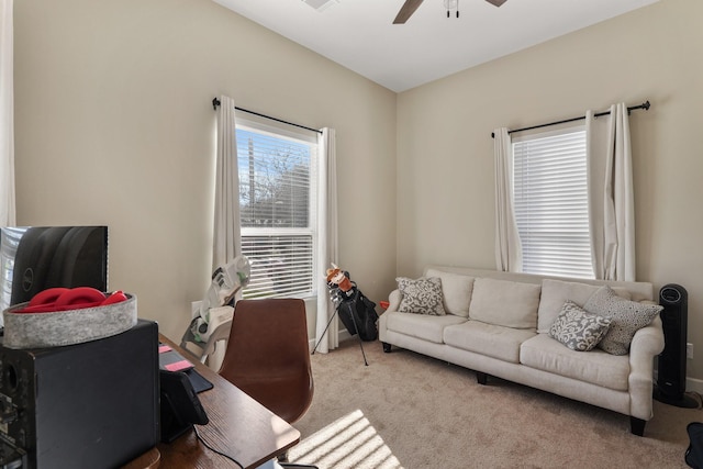 carpeted office space with ceiling fan