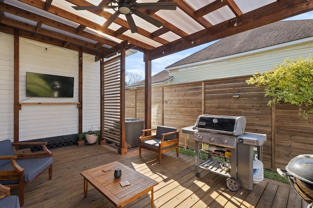 deck with ceiling fan, a pergola, and grilling area