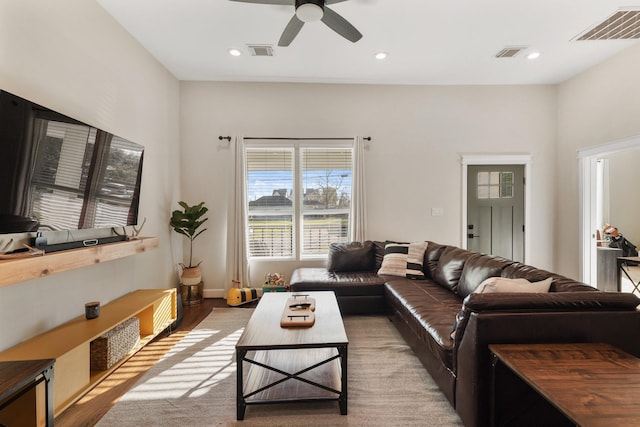 living room with ceiling fan and light wood-type flooring