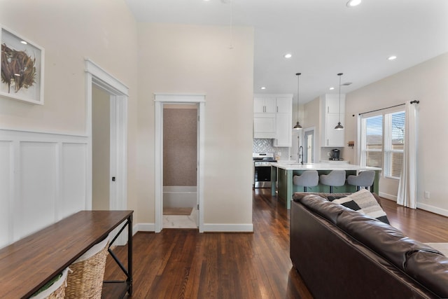 living room with sink and dark hardwood / wood-style flooring