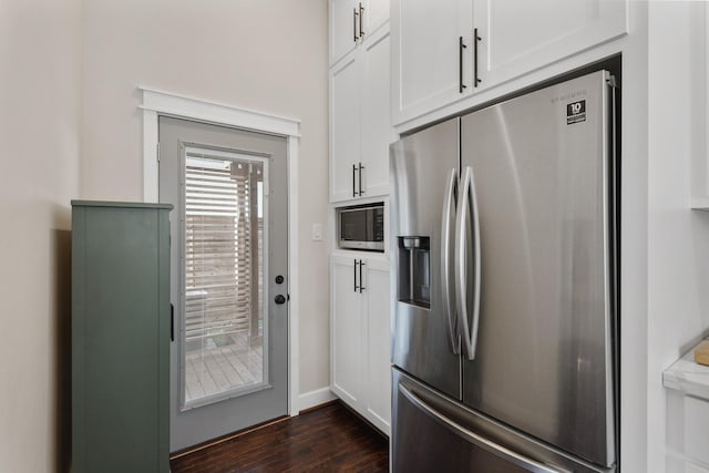 kitchen featuring stainless steel refrigerator with ice dispenser, white cabinets, dark hardwood / wood-style flooring, and built in microwave