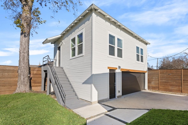 view of side of home with a yard and a garage