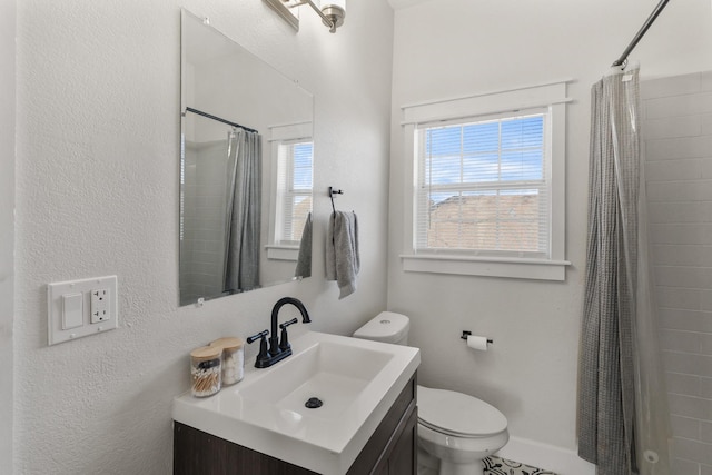 bathroom with toilet, vanity, and a shower with curtain