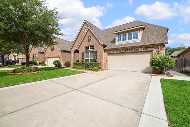 view of front of home featuring a garage and a front yard