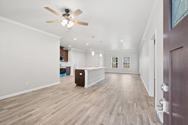 unfurnished living room featuring ceiling fan, light wood-type flooring, and ornamental molding