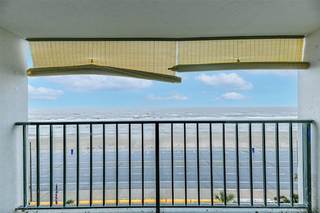 balcony with a beach view and a water view