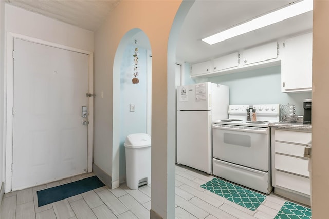 kitchen with white appliances and white cabinetry