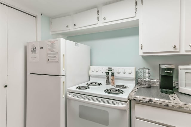 kitchen with white appliances and white cabinetry