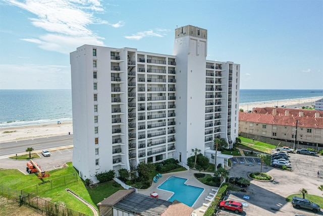 view of property with a beach view and a water view