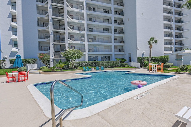 view of swimming pool featuring a patio area