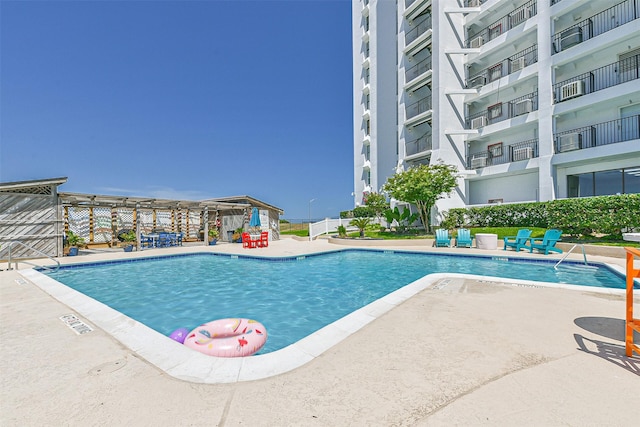 view of swimming pool with a patio area and a pergola