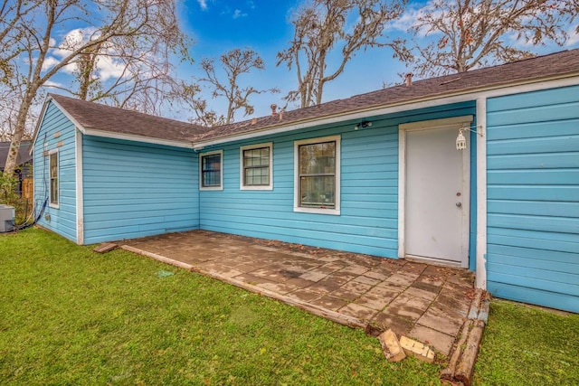 back of house featuring a patio and a yard