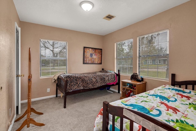 carpeted bedroom with multiple windows