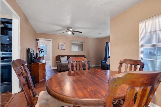 dining space featuring a textured ceiling and ceiling fan