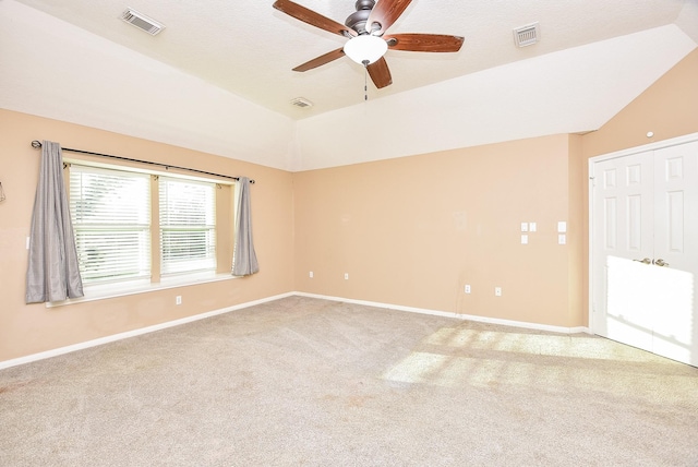 carpeted empty room with lofted ceiling and ceiling fan