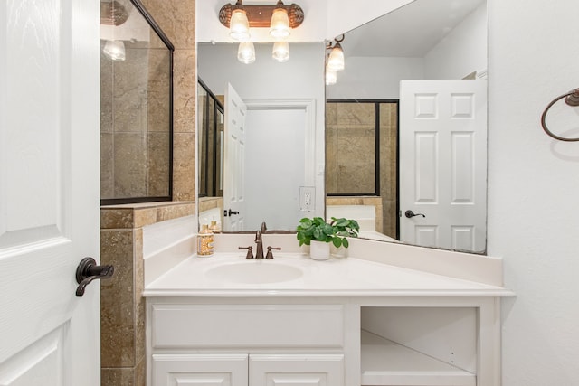 bathroom featuring an enclosed shower and vanity