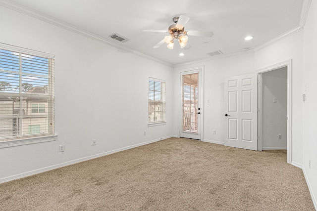 empty room with ceiling fan, ornamental molding, and carpet flooring