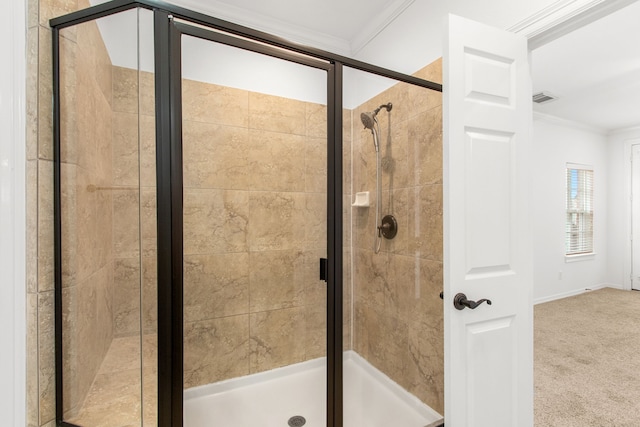 bathroom featuring a shower with door and ornamental molding