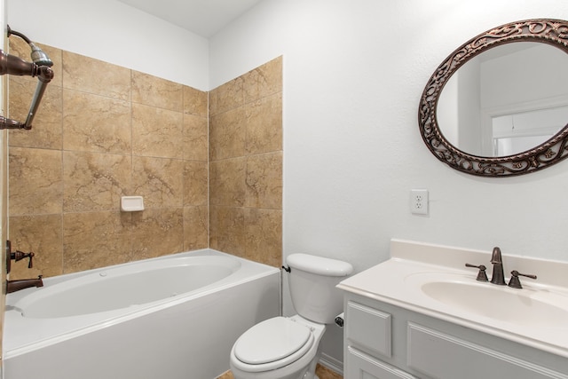 full bathroom with tiled shower / bath, vanity, and toilet