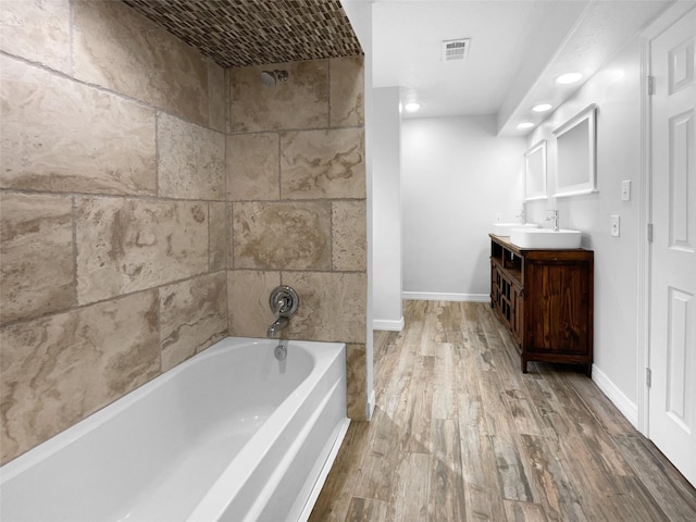 bathroom with shower / bathing tub combination, vanity, and wood-type flooring