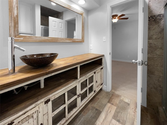 bathroom featuring ceiling fan and vanity