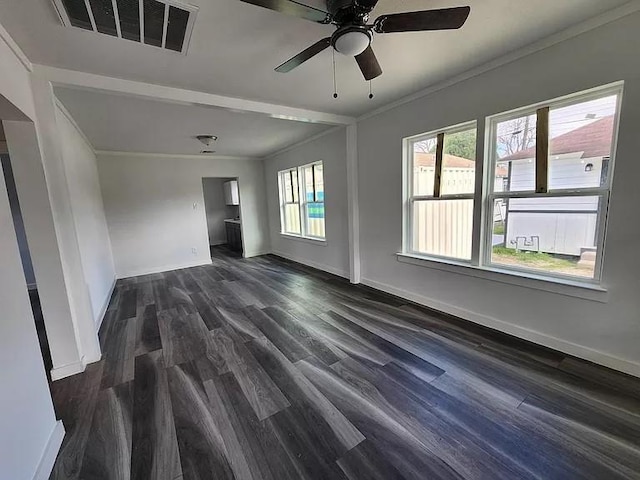 empty room with ceiling fan, dark hardwood / wood-style flooring, crown molding, and plenty of natural light