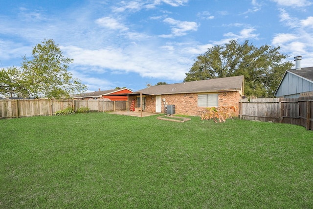 back of property featuring a lawn, cooling unit, and a patio area