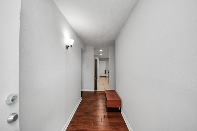 corridor featuring dark wood-type flooring